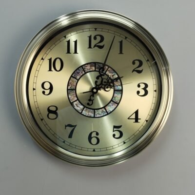 gold metal wall clock with decorative mosaic inlay
