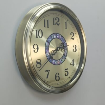 gold metal wall clock with decorative mosaic inlay
