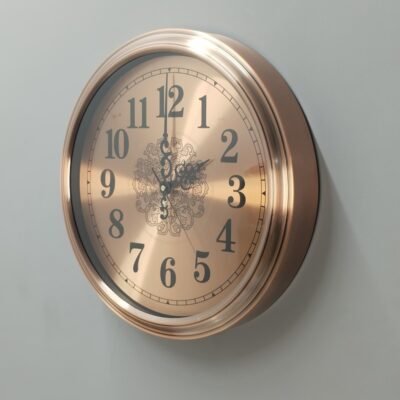 gold metal wall clock with decorative mosaic inlay