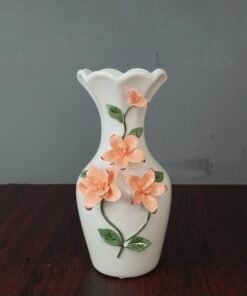 elegant white ceramic flower vase with 3d peach floral embossment elegant white ceramic flower vase with 3d peach floral embossment